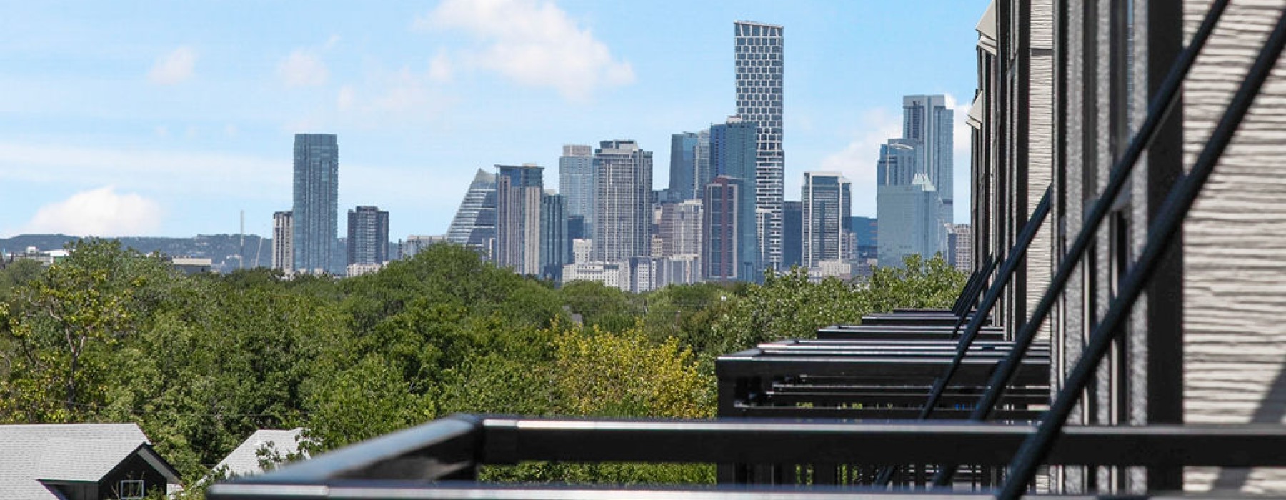 Balcony with views of nearby homes at Residences at Rubi apartments near UT Austin.