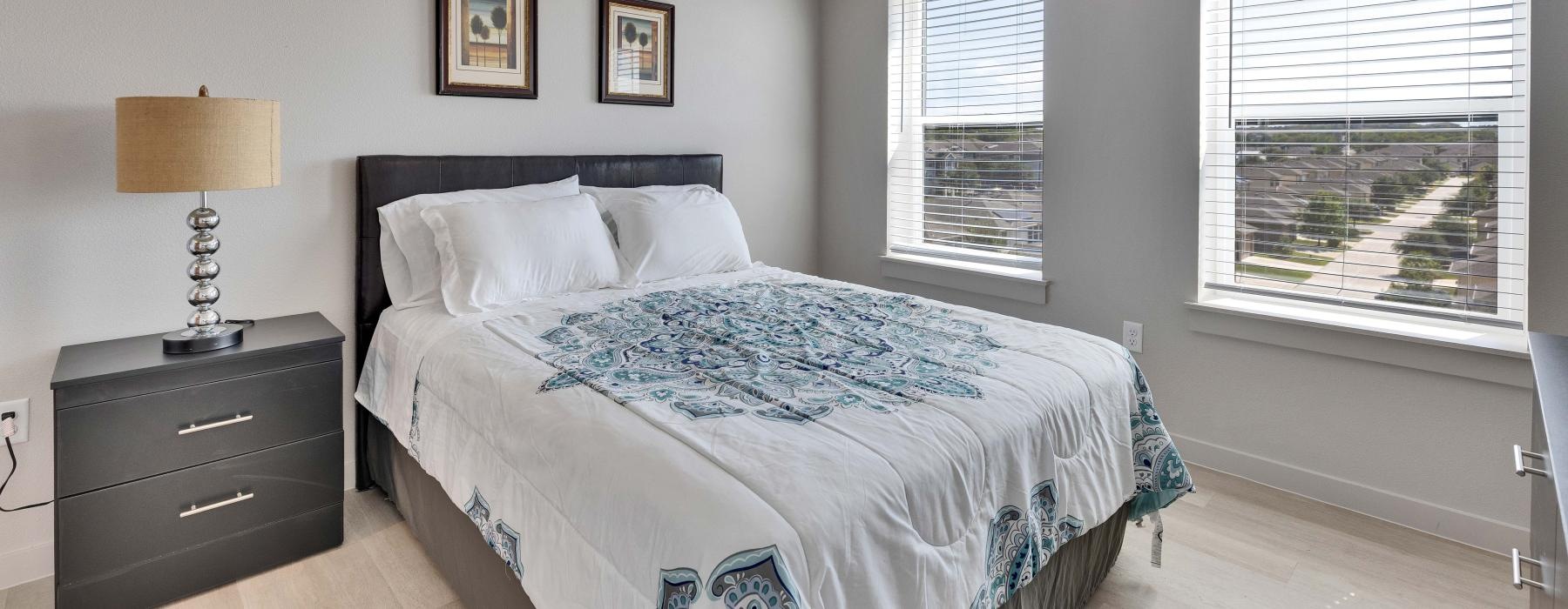 a bedroom with a bed and a fan