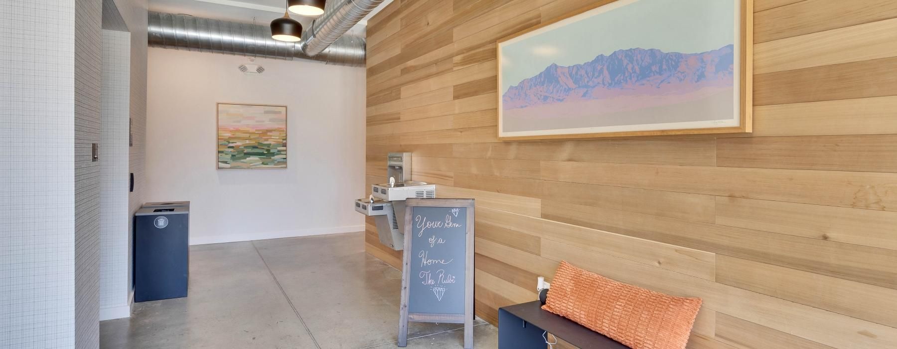 a room with a bench and a painting on the wall