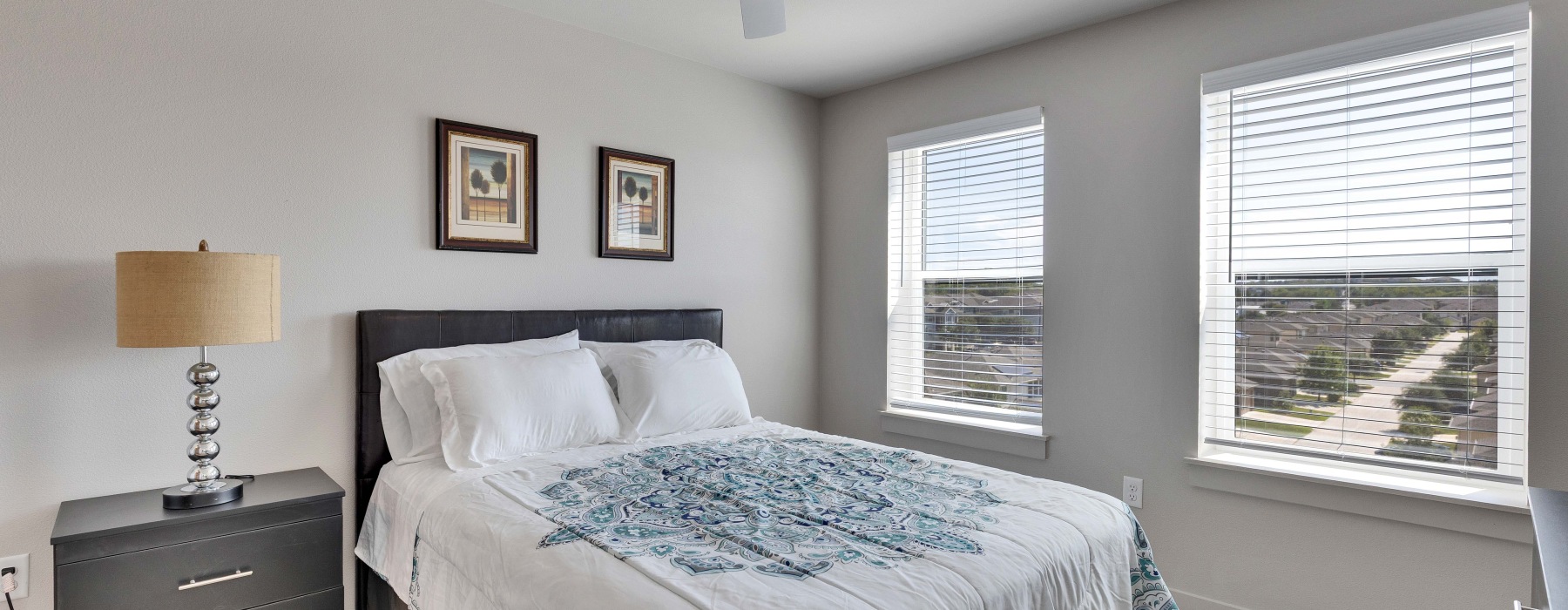 spacious bedroom with windows