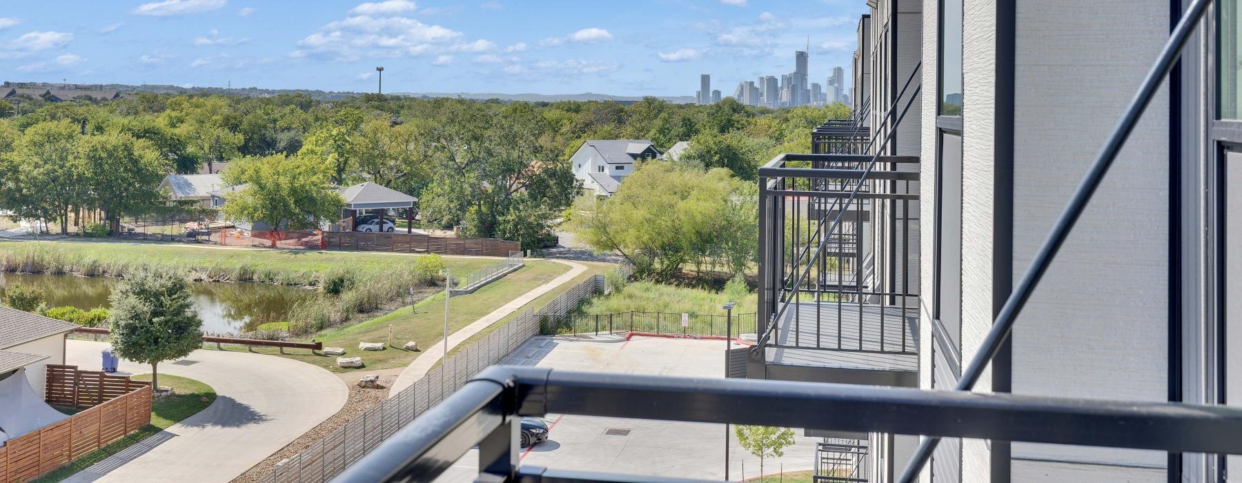 a building with a fence and trees in the back